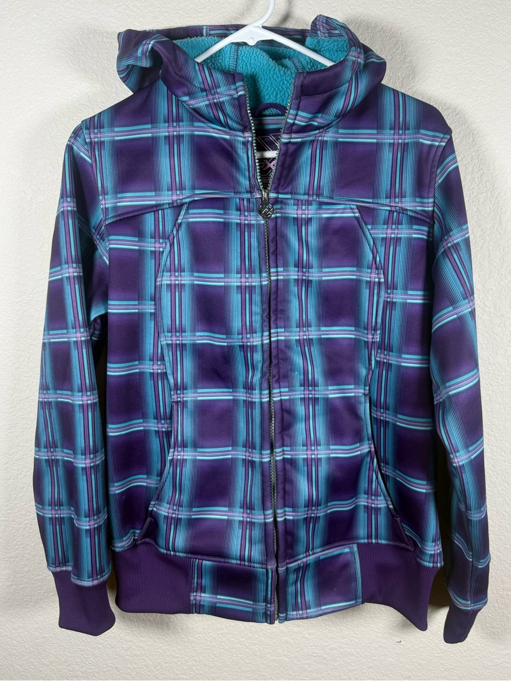 ZeroXposur Girls Purple Plaid Hooded Puffer Jacket with Turquoise Accents.